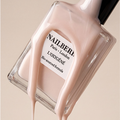 Nail polish bottle with a beige color and 'Nailberry' branding on a beige background